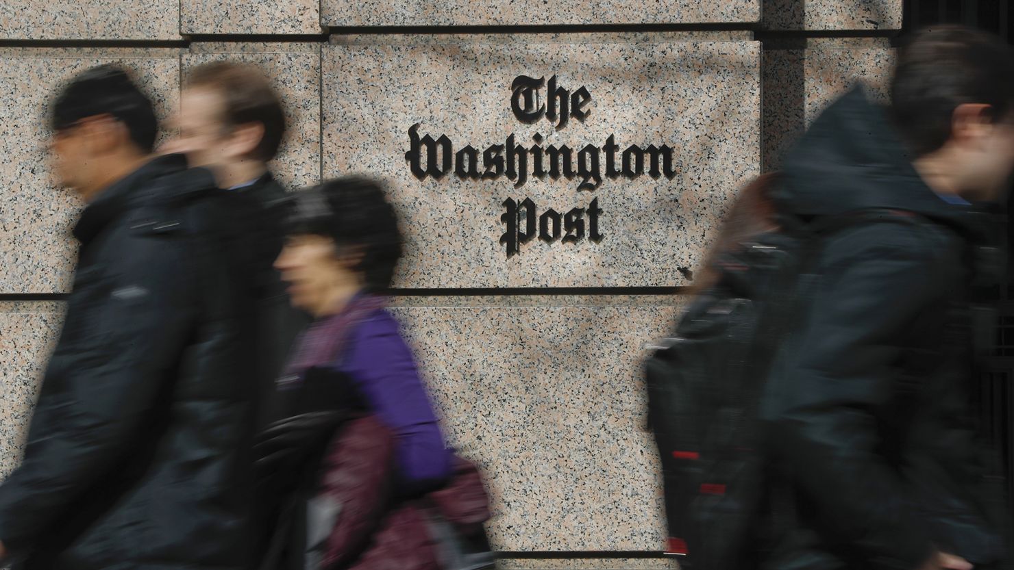 In this Thursday, Feb. 21, 2019, file photo, people walk by the One Franklin Square Building, home of The Washington Post newspaper, in downtown Washington. 