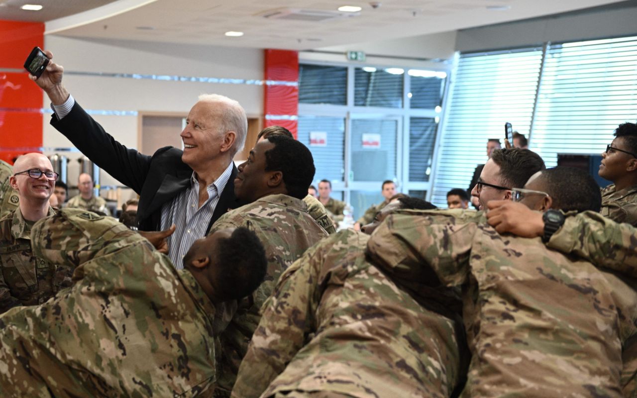 Biden takes a selfie with US service members in Poland on Friday.