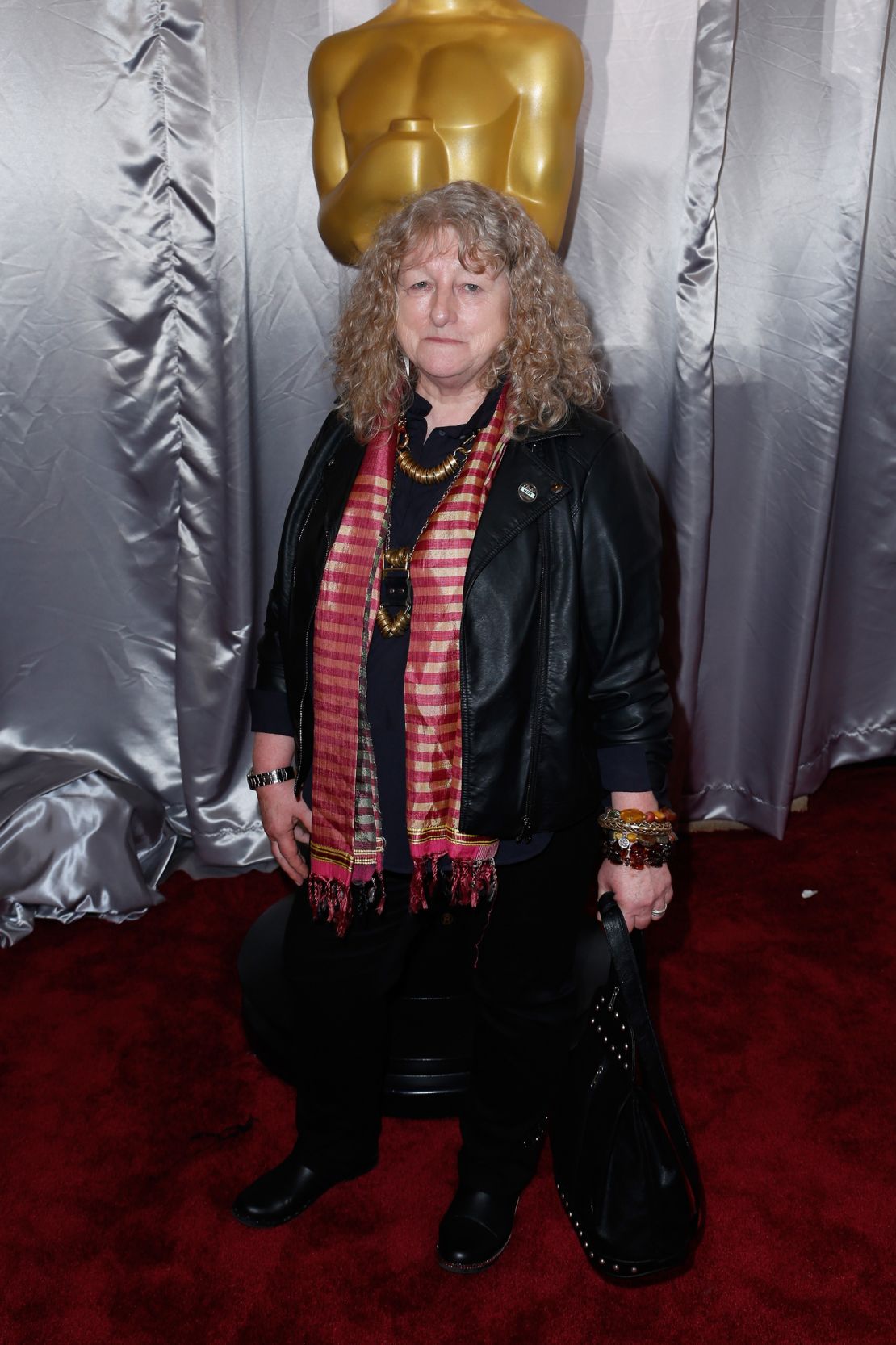 Costume designer Jenny Beavan defied sartorial convention by wearing a pleather jacket and black trousers to the Oscars in 2016.