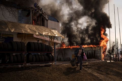 A man recovers items from a burning shop following a Russian attack in Kharkiv on March 25.