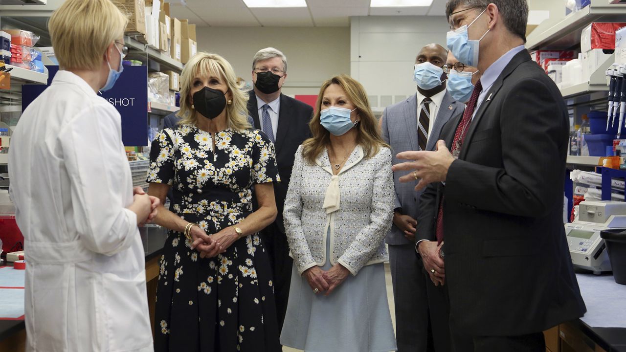 First lady Jill Biden meets Dr. Charles W. M. Roberts, right, and Giedre Krenciute, left, as she visits the pediatric brain tumor lab at St. Jude Children's Research Hospital, Friday, March 25, 2022, in Memphis, Tenn. 