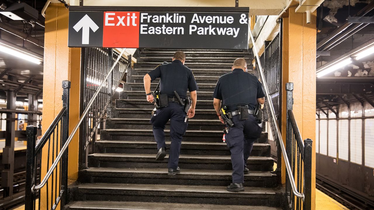 NYPD officers patrol the Franklin Avenue subway station last July in New York, where a crackdown on quality-of-life offenses has renewed debate over "broken windows" policing.