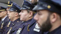 A female police officer stands with her male police department colleagues in New York City on Tuesday, November 2, 2021. (AP Photo/Ted Shaffrey)