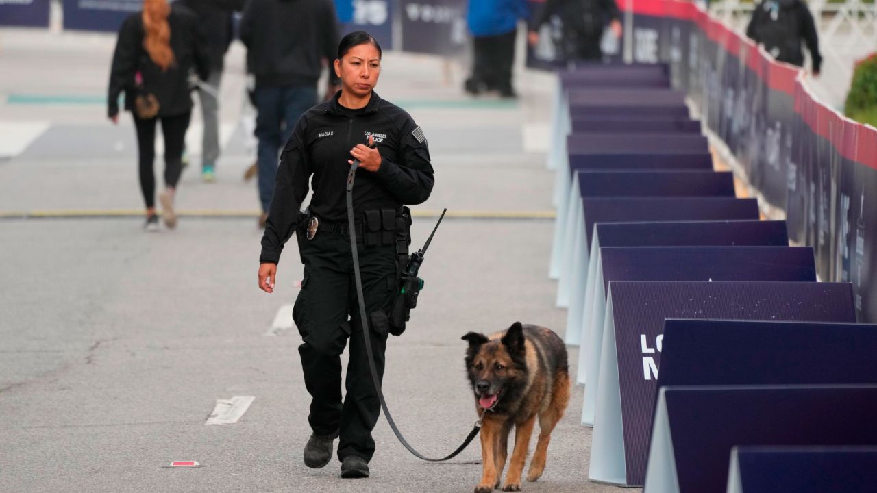 A Los Angeles Police Bomb Detection female officer with her K-9 dog.