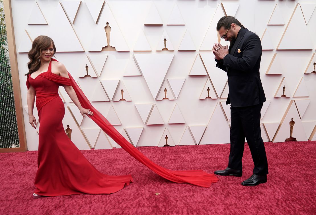 Actress Rosie Perez in a red Christian Siriano dress alongside Oscars presenter Jason Momoa. 