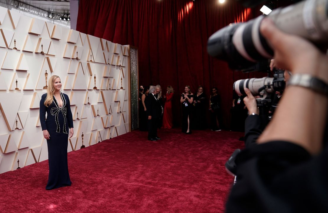 Oscars host Amy Schumer sporting an Oscar de la Renta deep-plunge neckline with diamonds forming the outline of a bow.