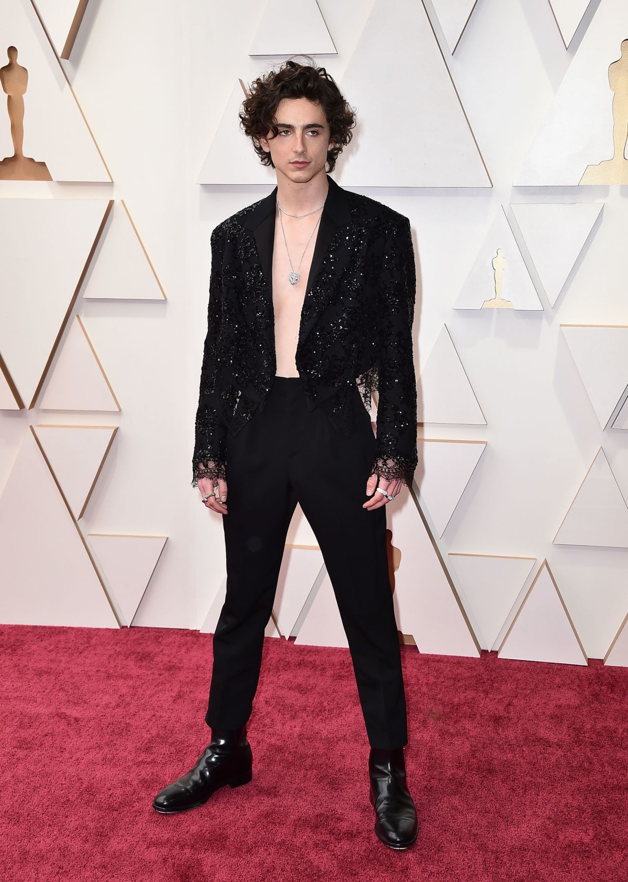 Timothée Chalamet bolstered his reputation as one of Hollywood's boldest dressers in an embroidered lace jacket and high-waisted pants from Louis Vuitton's Spring-Summer 2022 womenwear line. 