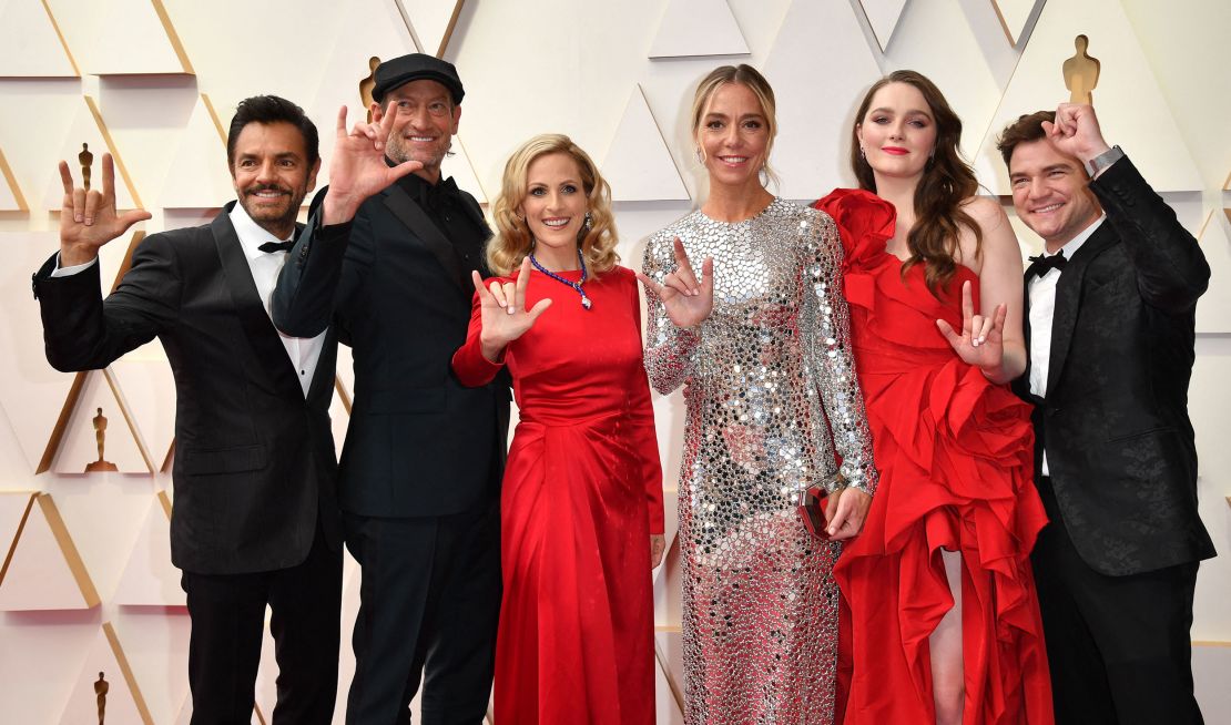From left, Eugenio Derbez, Troy Kotsur, Marlee Matlin, Sian Heder, Amy Forsyth and Daniel Durant wearing complementary outfits.