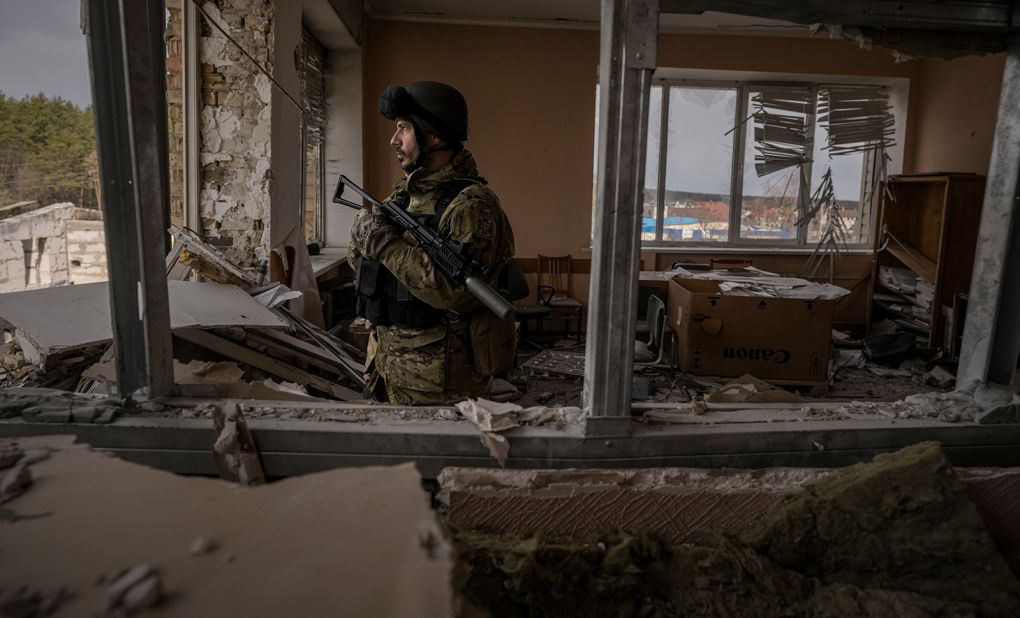 A Ukrainian serviceman stands in a heavily damaged building in Stoyanka, Ukraine, on March 27.