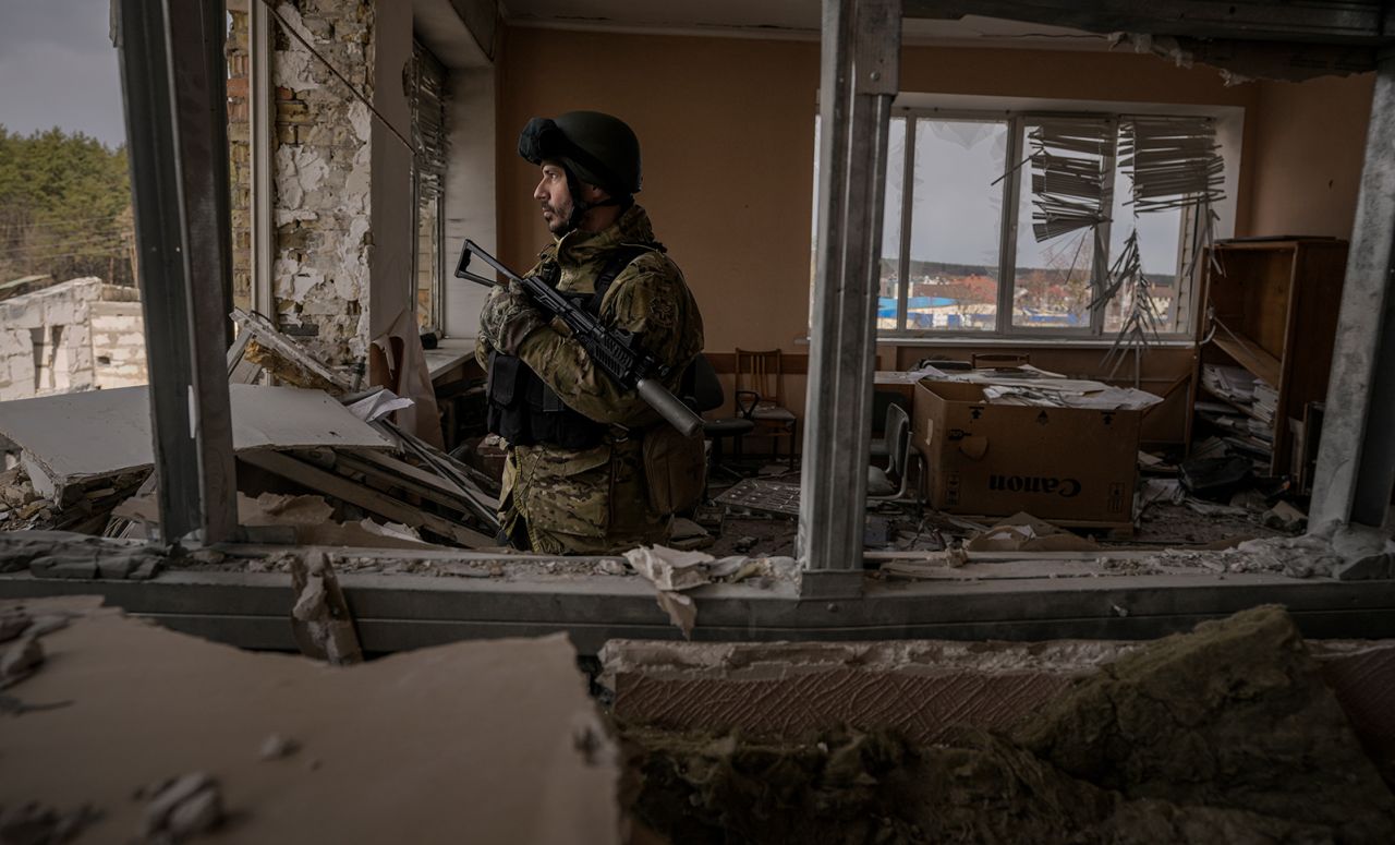 A Ukrainian serviceman stands in a heavily damaged building in Stoyanka, Ukraine, on March 27.  Zelensky says Russia waging war so Putin can stay in power &#8216;until the end of his life&#8217; 220327191900 01 ukraine russia crisis 0327