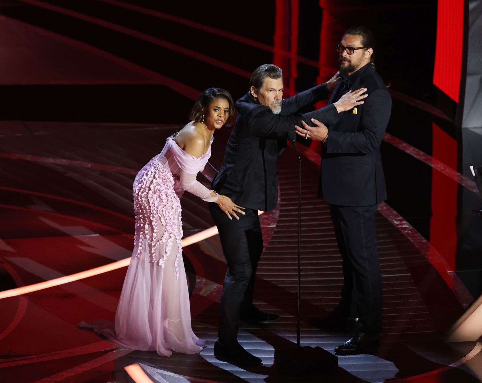 Co-host Regina Hall frisks Josh Brolin before he and Jason Momoa presented an award.