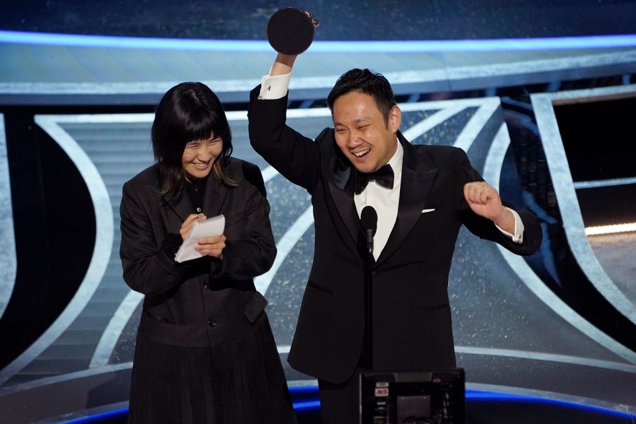 Ryusuke Hamaguchi, director of "Drive My Car," celebrates after winning the Oscar for best international feature film.