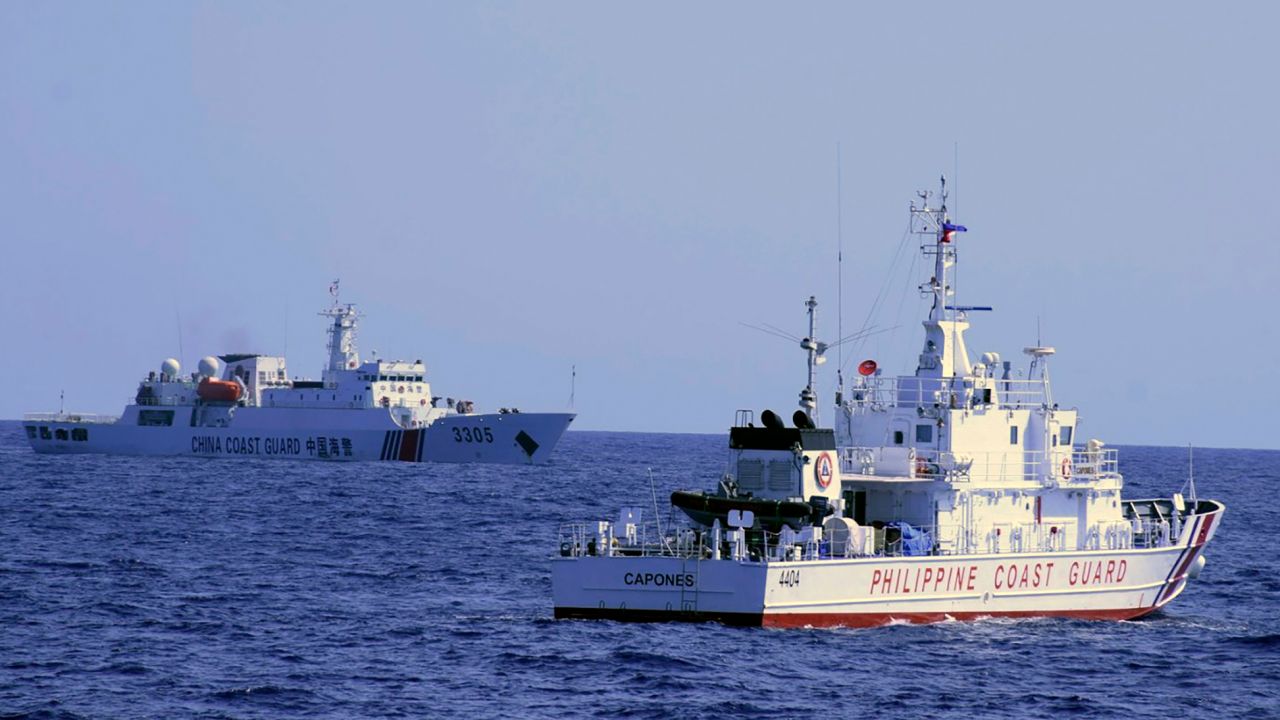 In this photo provided by the Philippine Coast Guard, a Chinese Coast Guard ship sails near a Philippine Coast Guard vessel during its patrol at Bajo de Masinloc, 124 nautical miles west of Zambales province northwestern Philippines on March 2, 2022. 
