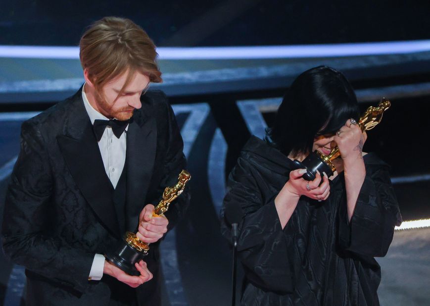 Billie Eilish and her brother, Finneas O'Connell, react after winning the Oscar for best original song ("No Time to Die").
