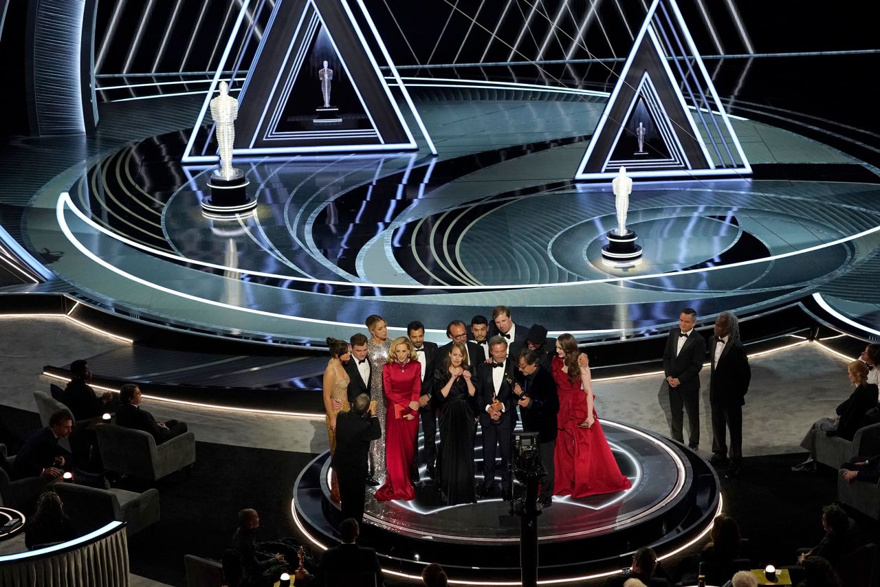 The cast and crew of "CODA" accepts the Oscar for best picture.