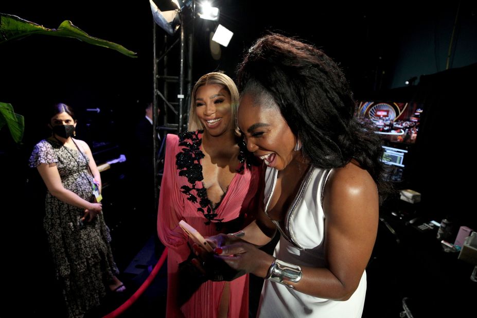 Tennis stars Serena Williams, center, and Venus Williams are seen backstage during the show.