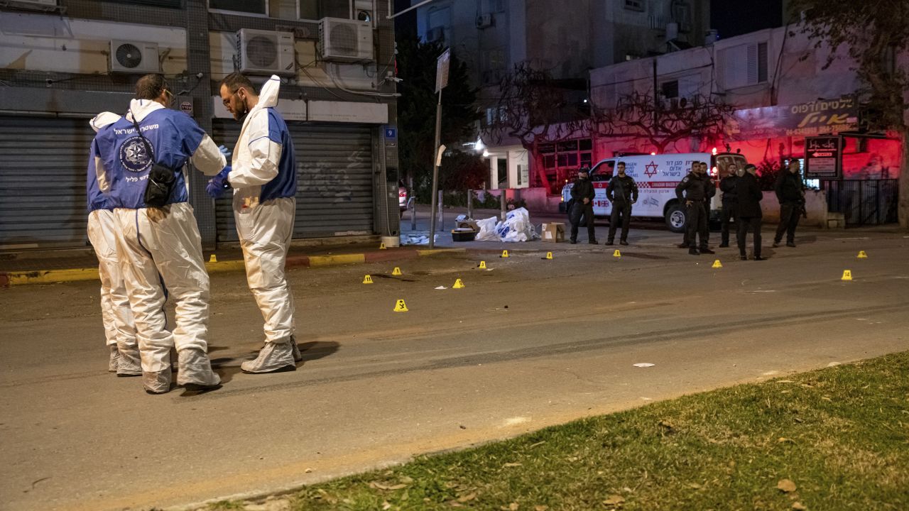 Police and forensics officers at the scene of the shooting in Hadera, Israel on Sunday, March 27