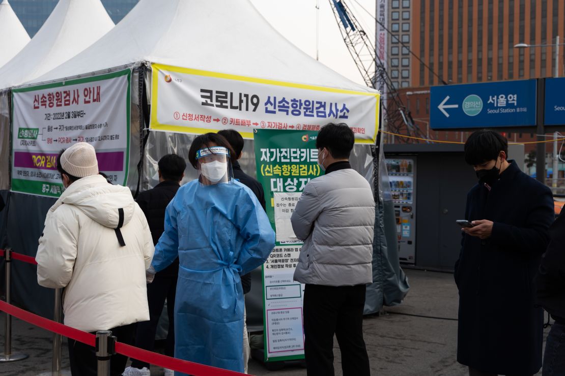Members of the public wait in line at a temporary Covid-19 testing station set up outside Seoul Station on March 4, 2022.