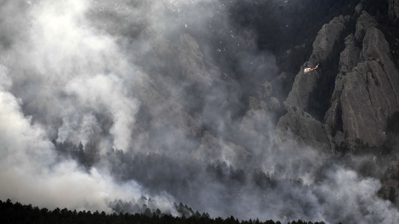 A helicopter flies above smoke from the NCAR fire Saturday.