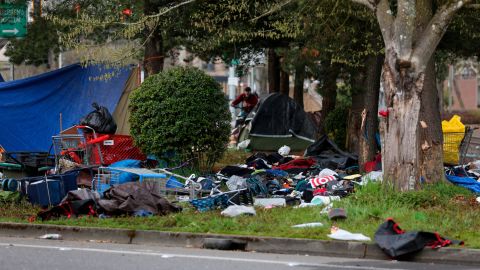 A homeless camp sits in ruins Sunday after a vehicle crashed into it, killing several people.