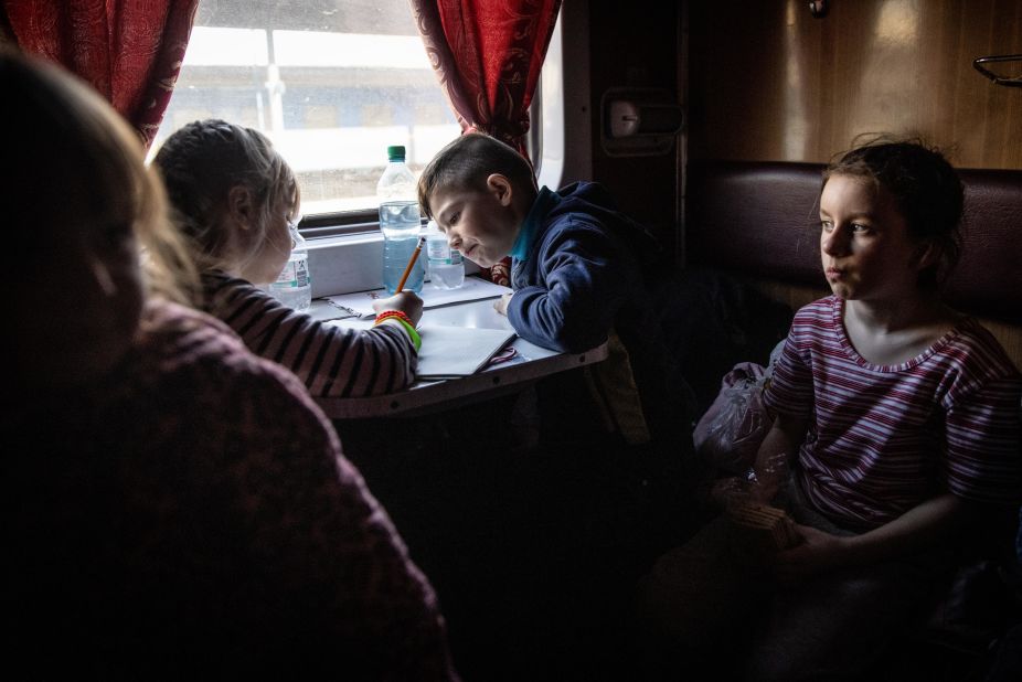 Orphaned children travel by train after fleeing the Russian-controlled town of Polohy, Ukraine, on March 26.