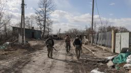 Ukranian servicemen walk through the village of Lukyanivka outside Kyiv, as Russia's invasion of Ukraine continues, Ukraine, March 27, 2022. 