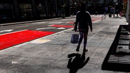 A pedestrian carries a shopping bag in San Francisco, California, U.S., on Monday, Feb. 28, 2022. 