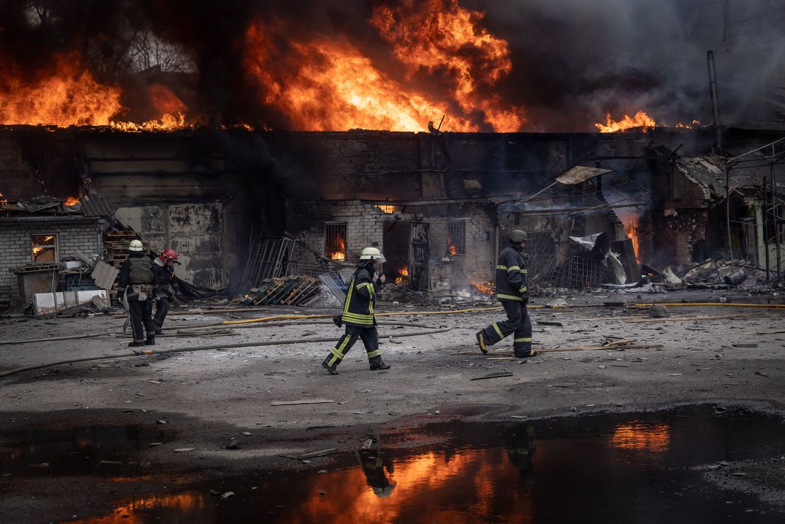 Firefighters work to extinguish a fire at a warehouse after it was hit by Russian shelling on March 28, 2022 in Kharkiv, Ukraine. 