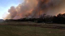 This was taken by on 03/27/2022. Amanda Burson Latham says she went to Fort Hood to help a friend move their farm equipment and that's when she came across the fire. After they were at the location for a while they witnessed plane begin to drop fire retardant. Latham says luckily the wind changed direction and her friend's property was not damaged.
"The flames were 30-40 feet high and there was a mixture of black and rust colored smoke that covered the sun and make everything an eerie color. You could feel the heat of off it and hear the trees breaking and cracking and the fire roaring. There were about 5 different Fire Departments coming up and down the road, they were protecting houses in the path of the fire."