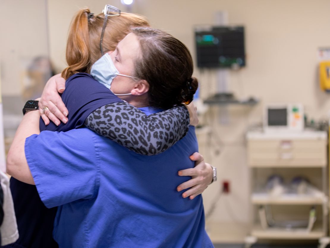 US Air Force Maj. Tonya Toche-Howard, right, hugs a staff member on her last day at Signature Healthcare Brockton Hospital on March 15.