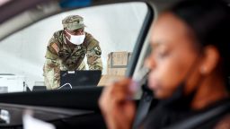 NEW ORLEANS, LOUISIANA - AUGUST 11: Louisiana Army National Guard soldier Sonny Brown keeps watch while a driver administers a self-collected nasal swab at a COVID-19 drive-through testing site operated by the National Guard on August 11, 2021 in New Orleans, Louisiana. The Louisiana Department of Health today reported 3,930 new confirmed COVID-19 cases and 42 additional deaths. 2,895 COVID-19 patients are now hospitalized in Louisiana, a new daily record.  (Photo by Mario Tama/Getty Images)