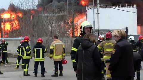 CNN footage from the scene of a fire at a fuel storage facility in the Ukrainian city of Lviv on Saturday. One firefighter was seen in a coat that said "EDMONTON" on the back -- because it was donated from the Canadian city of Edmonton.