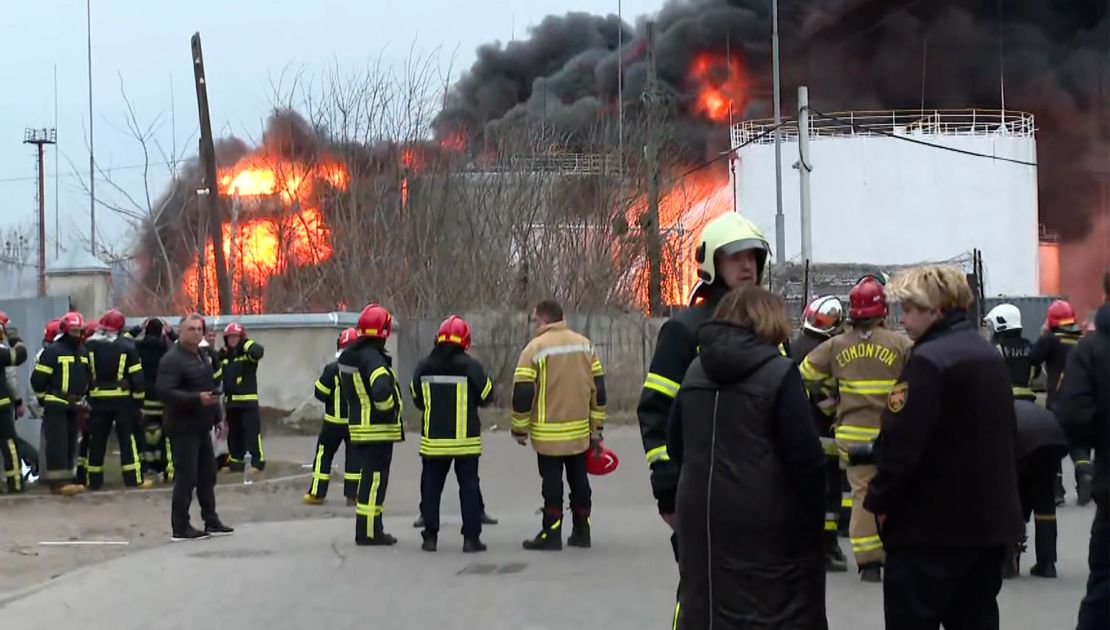 CNN footage from the scene of a fire at a fuel storage facility in the Ukrainian city of Lviv on Saturday. One firefighter was seen in a coat that said "EDMONTON" on the back -- because it was donated from the Canadian city of Edmonton.