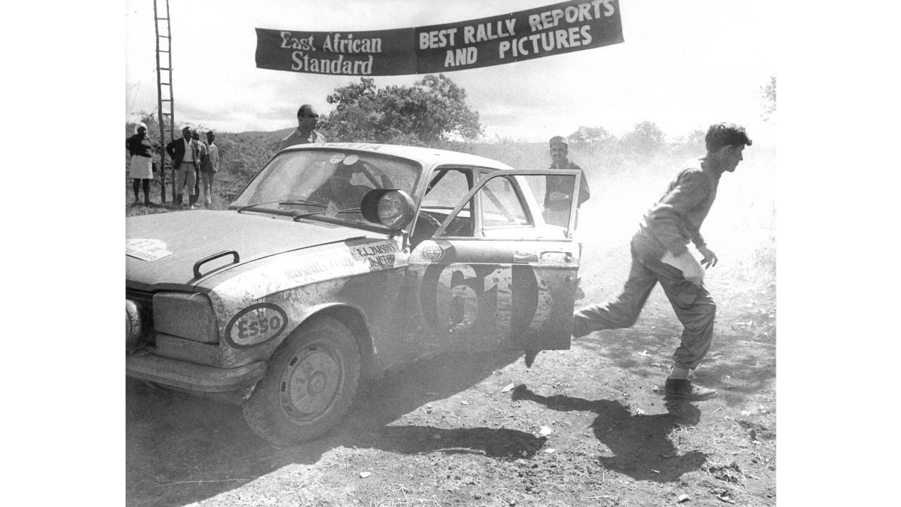 A car makes a stop during the 1971 East African Safari Rally. The rally was raced across multiple countries in its earlier iterations, and became part of the World Rally Championship (WRC) calendar in the 1970s.