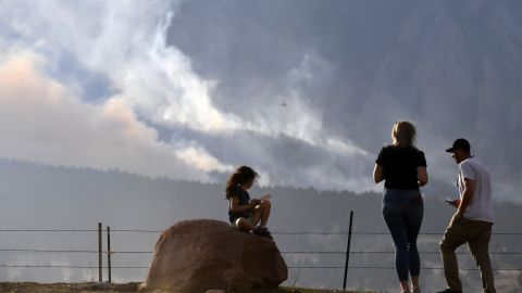 People watch as the NCAR Fire near Boulder burns in the foothills south of the National Center for Atmospheric Research on Saturday.