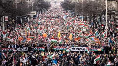 Supporters of Orban's Fidesz party march in Budapest on March 15. Orban has been adamant that he will not support sanctions that target Russian energy experts. 