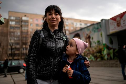 A woman named Julia cries next to her 6-year-old daughter, Veronika, while talking to the press in Brovary, Ukraine, on March 29.