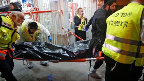 Israeli emergency services remove a victim's body from the scene of the attack in Bnei Brak on Tuesday.