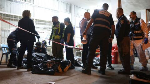 Israeli police and paramedics gather near bodies of people killed by a gunman in Bnei Brak, Israel on Tuesday.