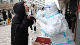 A resident undergoes a nucleic acid test for the Covid-19 coronavirus in Shenyang, in China's northeastern Liaoning province on March 29, 2022. - China OUT (Photo by AFP) / China OUT (Photo by STR/AFP via Getty Images)
