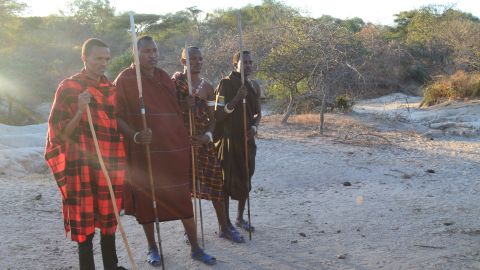 Stephano Asecheka (pictured second from left) is part of a team of "Lion Defenders" who track lions and work with the community to reduce risk to both human and lion populations.