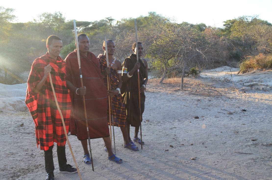 Stephano Asecheka (pictured second from left) is part of a team of "Lion Defenders" who track lions and work with the community to reduce risk to both human and lion populations.