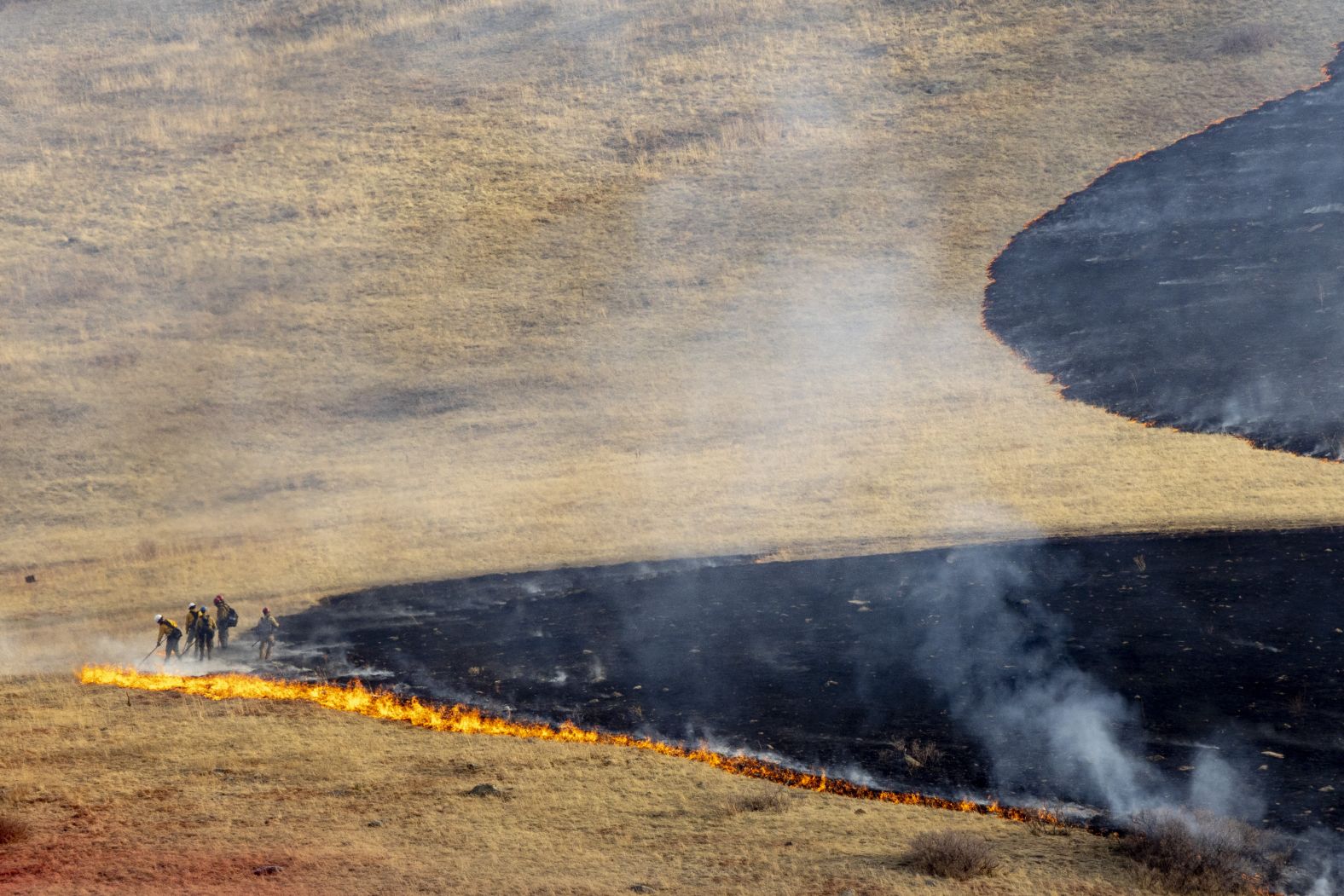 Firefighters battle the NCAR Fire in Boulder on March 26.