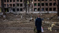 TOPSHOT - A woman stands in front of a destroyed building after a Russian missile attack in the town of Vasylkiv, near Kyiv, on February 27, 2022. - Ukraine's foreign minister said on February 27, that Kyiv would not buckle at talks with Russia over its invasion, accusing President Vladimir Putin of seeking to increase "pressure" by ordering his nuclear forces on high alert. (Photo by Dimitar DILKOFF / AFP) (Photo by DIMITAR DILKOFF/AFP via Getty Images)