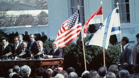 Egyptian President Anwar al-Sadat (L), US President Jimmy Carter and Israeli Premier Menachem Begin (R) laugh before sign of the Israel-Egypt Peace Agreement on March 26, 1979 on the north lawn of the White House, Washington DC. 