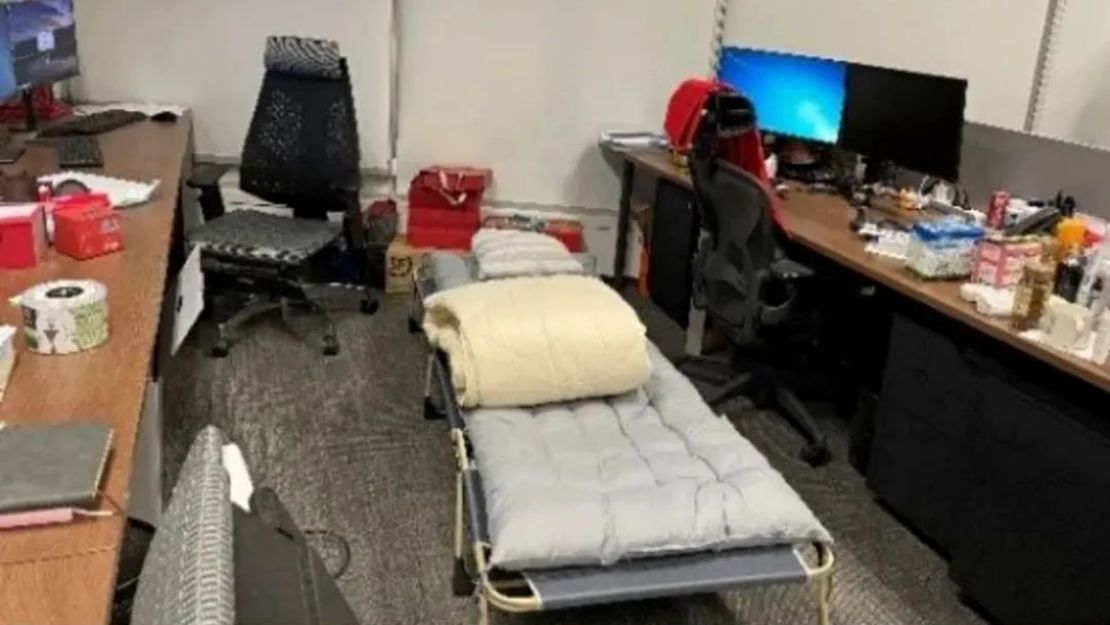 A folding bed set up between desks at a firm in Shanghai. 