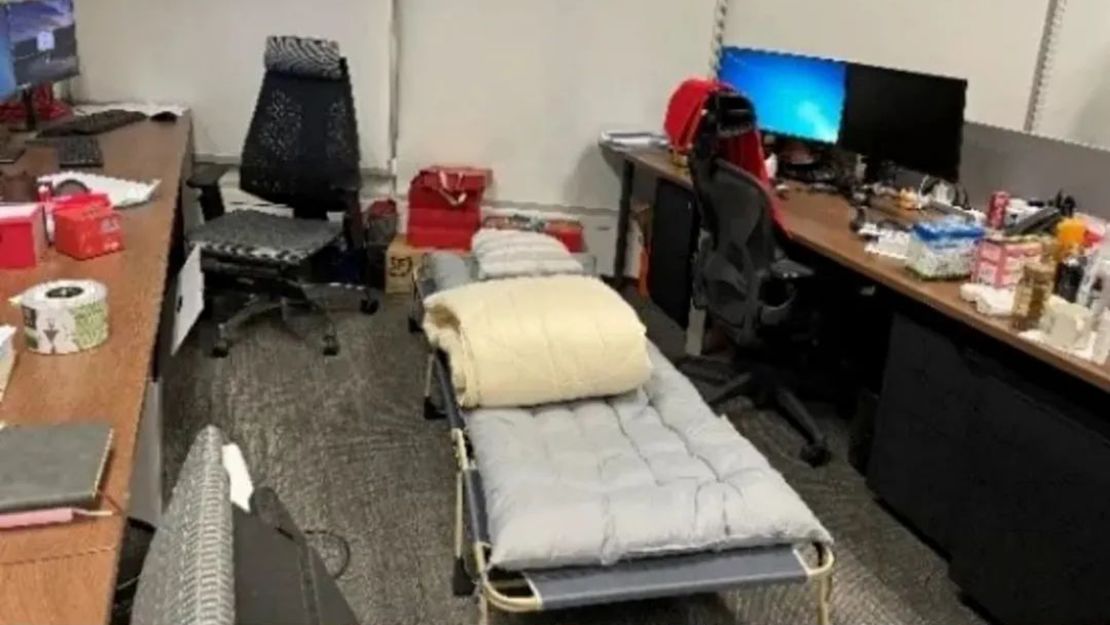 A folding bed set up between desks at a firm in Shanghai.