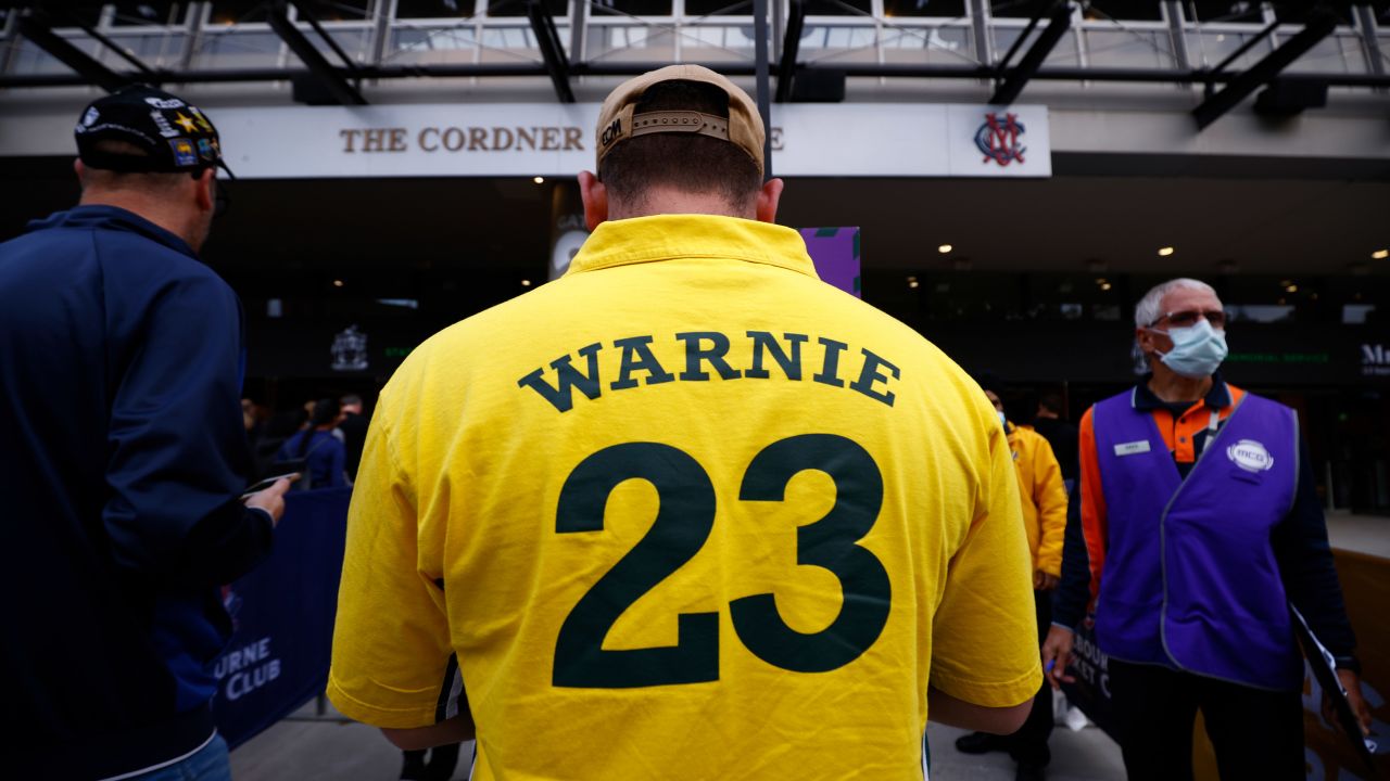 A man wearing a "Warnie" jersey attends the state memorial service for former Australian cricketer Warne.