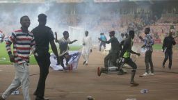 Police fire tear gas to chase pitch invaders at the end of Ghana and Nigeria 2022 Qatar World Cup qualifying playoff second leg soccer match, at Moshood Abiola Stadium, in Abuja, Nigeria, Tuesday, March. 29, 2022. Ghana became the first team from Africa to qualify for the World Cup in Qatar after a 1-1 draw with Nigeria in the second leg of their playoff on Tuesday to advance on away goals. (AP Photo/Sunday Alamba)