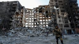 FILE PHOTO: A service member of pro-Russian troops walks near an apartment building destroyed in the course of Ukraine-Russia conflict in the besieged southern port city of Mariupol, Ukraine March 28, 2022. REUTERS/Alexander Ermochenko/File Photo